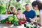 Family discusses the harvest of vegetables at the table of the village house