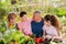 Family discusses the harvest of vegetables at the table of the village house