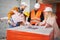 Family discussing building plan with builder at construction site.