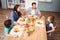 Family discussing with food on dining table