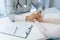 Family doctor comforts the patient, holds her hand