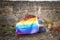 Family with a dog sitting with unrecognizable back covered with a rainbow flag