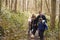 Family and dog walk in a wood, boy turning round, close up