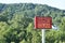 Family Dollar outdoor tall sign against rural wooded hill