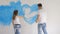 Family draw heart on a wall with a blue paint. Happy day concept