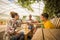 Family drinking and cheers together in outdoor leisure activity in a restaurant made by recycled wood and in respect with the