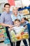 Family drives cart with food and boy sitting there