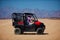 Family is driving a buggy car through the desert. extreme tourism adventures