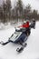 Family driving snowmobile in Ruka of Lapland