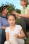 Family in early fall park. little girl in focus.