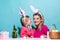 Family easter. Ester for mother and daughter. Mom with child are preparing for Easter. Mother and daughter wearing bunny