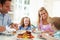 Family Eating Meal At Home Together