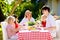 Family eating outdoor. Garden summer fun