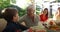 Family eating outside together in summer