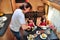 Family eating together in RV interior, travel in motorhome camper, caravan on vacation with kids