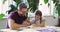 Family, education or homework with a father and daughter at a table in the living room of their home together. Kids