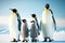 Family emperor penguin with small cubs against blue sky