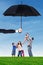 Family enjoy freedom at field under umbrella