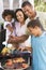 Family Enjoying A Barbeque