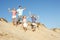 Family Enjoying Beach Holiday Running Down Dune