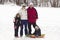 Family enjoying a day Snow sledding