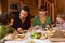 Family Enjoying Meal In Alpine Chalet Together