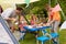 Family Enjoying Meal Outside Tent On Camping Holiday