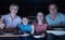 Family Enjoying Meal Whilst Watching TV