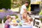 Family Enjoying Outdoor Barbeque In Garden