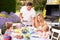 Family Enjoying Outdoor Barbeque In Garden