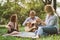 Family enjoying quality time, playing guitar in their green park garden