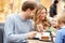 Family Enjoying Snack In Cafe Together