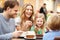 Family Enjoying Snack In Cafe Together