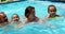 Family enjoying in swimming pool