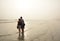 Family enjoying time together on beautiful foggy beach.