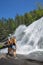 Family enjoying time together by the waterfall.