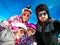 Family enjoying winter vacations taking selfie in skiing gear