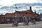 A family enjoys riding their bicycle, passing by Volendam Museum