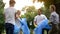 Family of enthusiasts doing voluntary Saturday work, picking garbage in park