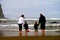 Family explores low tide tide pool on beach