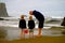 Family explores low tide tide pool on beach