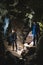 Family exploring huge cave. Adventure travellers dressed cowboy hat and backpack, group of people. vertical photo vacation,