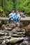 Family on a fallen tree across the river