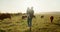 Family, farm and cattle with a girl and father walking on a field or grass meadow in the agricultural industry