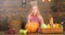 Family farm festival concept. Farm themed games and activities for kids. Girl kid at farm market with fall harvest