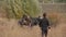 Family of farmers father and his two sons with horses preparing to work in field and graze cattle