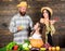 Family farmers with harvest wooden background. Parents and daughter celebrate autumn harvest festival. Family rustic
