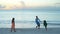 Family of father and little adorable kids enjoying beach vacation and playing together. SLOW MOTION