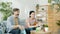 Family father and son watching sports on TV cheering holding ball then doing high-five