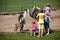 Family feeding animals in farm